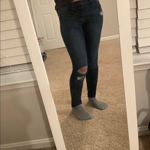 blue skinny jeans with a few rips